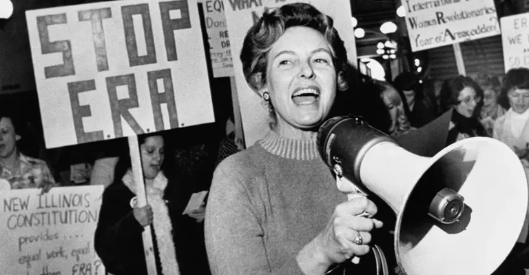 Phyllis Schlafly addressing a crowd through a megaphone