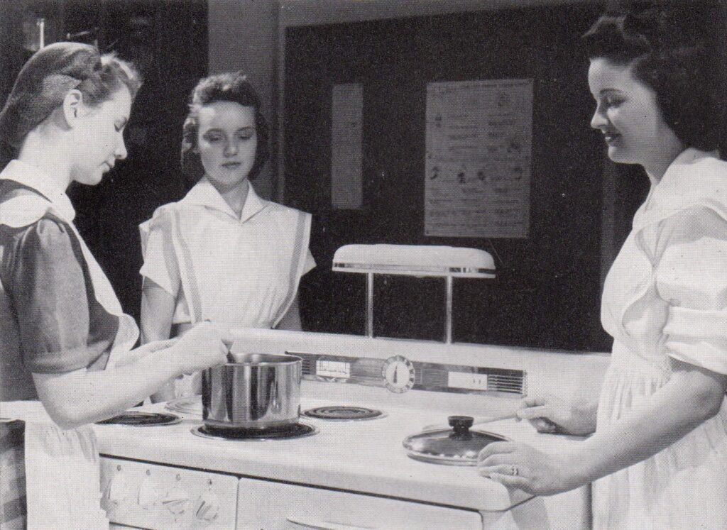 Students participating in a home economics cooking class in 1942