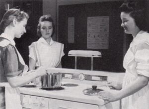 Students participating in a home economics cooking class in 1942