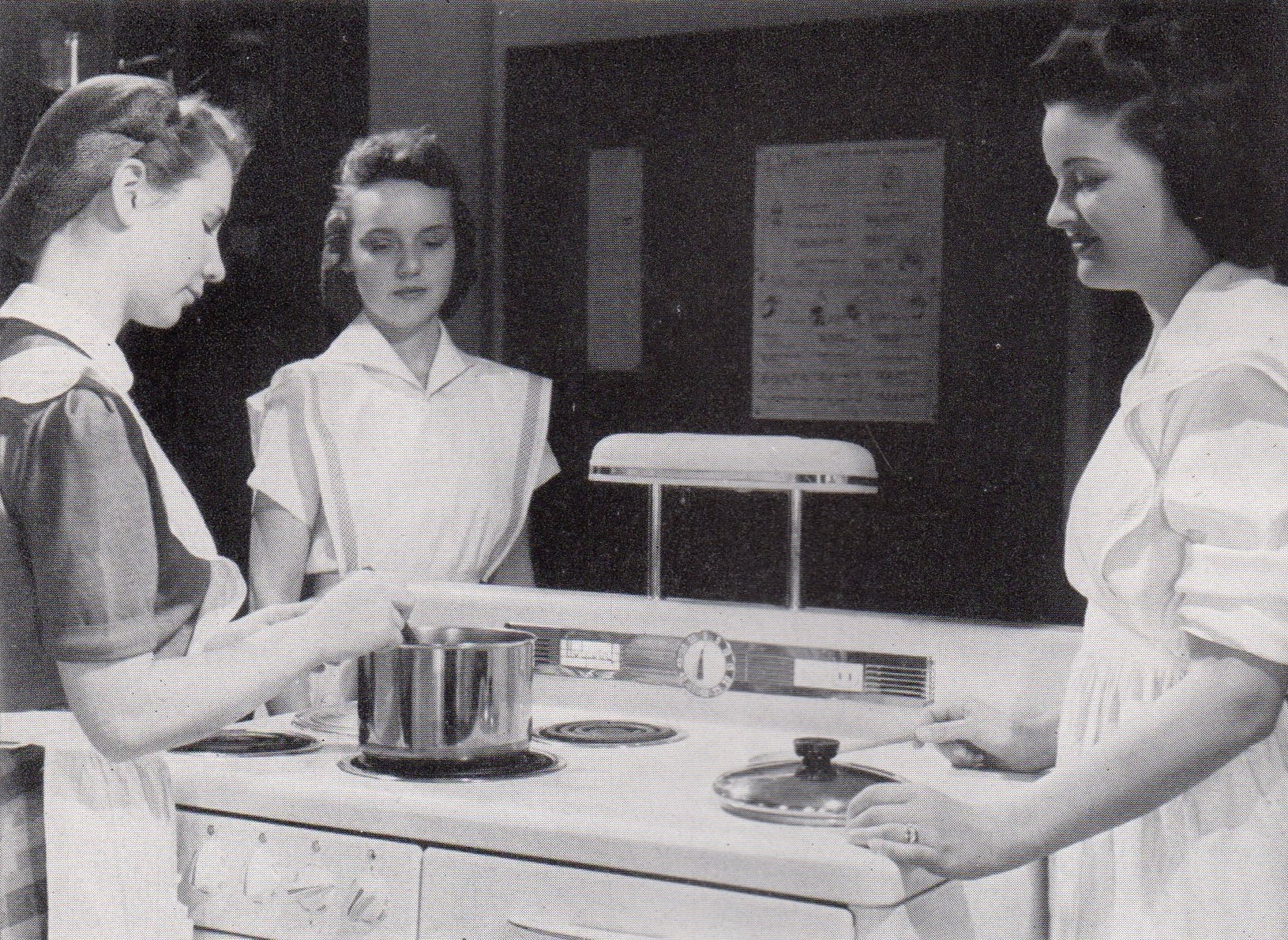 Students participating in a home economics cooking class in 1942