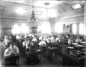 Students seated at desks in a classroom