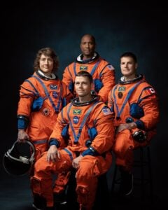 NASA Artemis II astronauts standing in flight suits