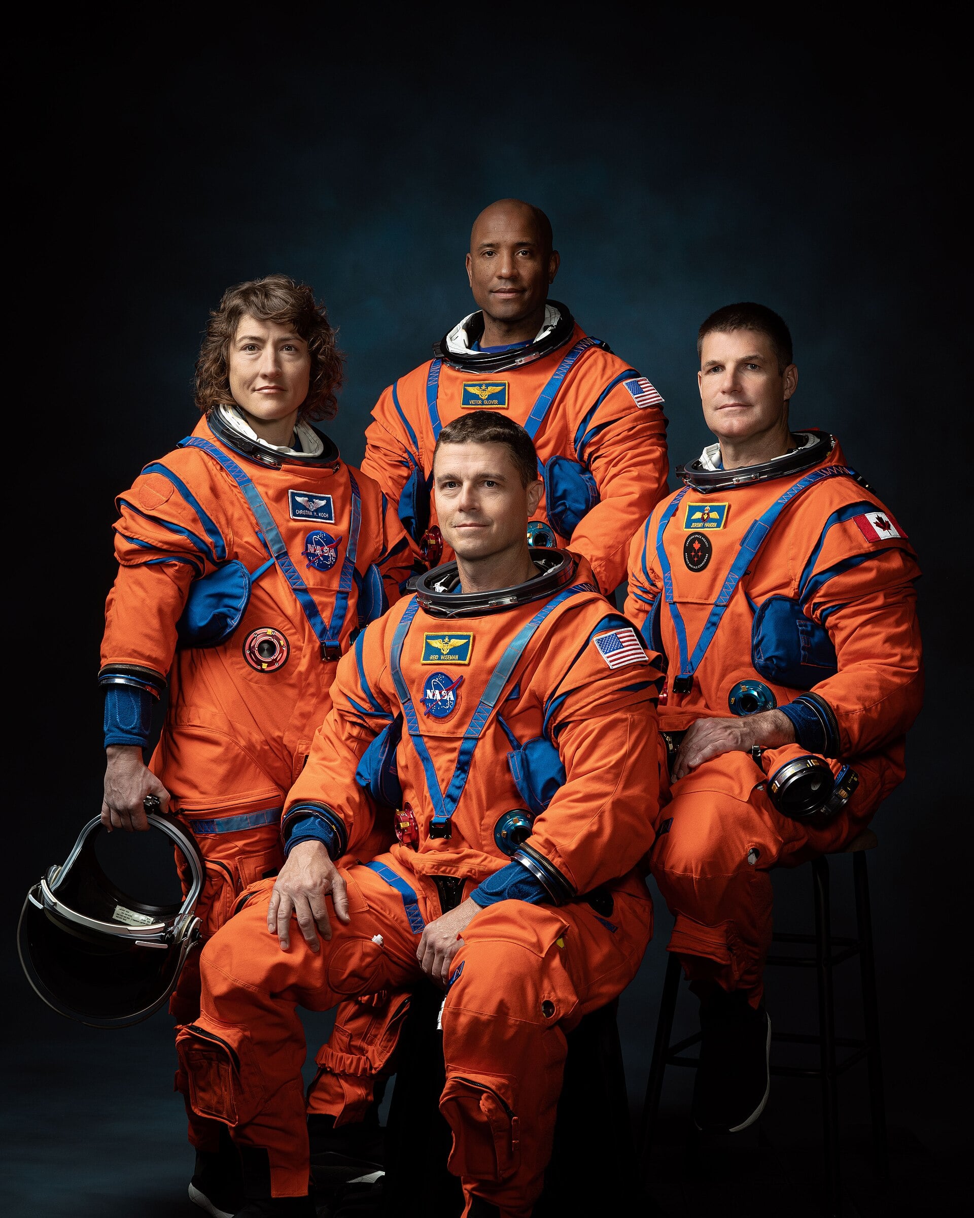 NASA Artemis II astronauts standing in flight suits