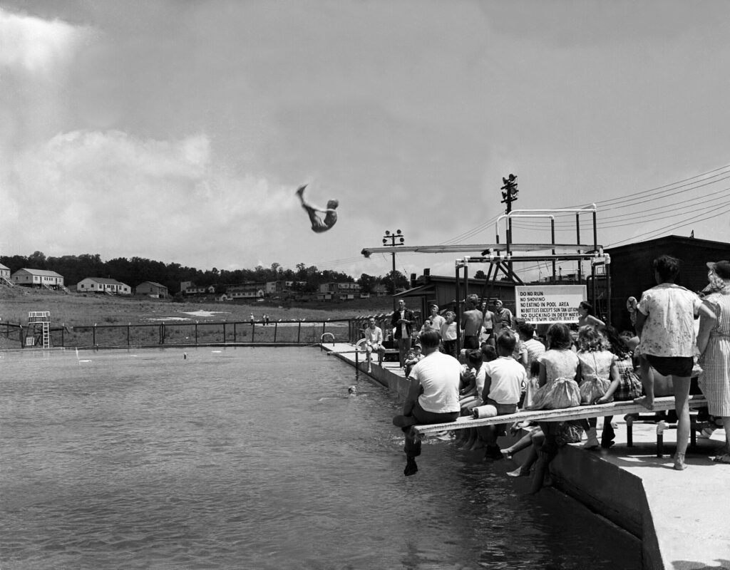 Diver competing above a swimming pool