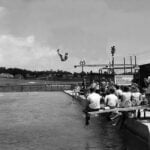 Diver competing above a swimming pool