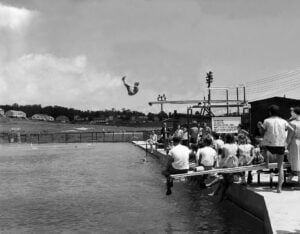Diver competing above a swimming pool