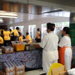 School cafeteria workers serving breakfast to students