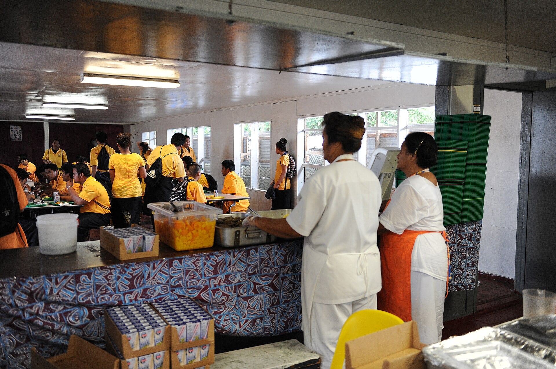 School cafeteria workers serving breakfast to students