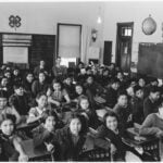 Students and teachers seated in a classroom