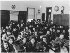 Students and teachers seated in a classroom