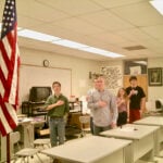 Students reciting the Pledge of Allegiance to the American flag