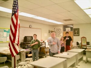 Students reciting the Pledge of Allegiance to the American flag