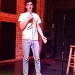 Stand-up comedian holding a microphone on stage